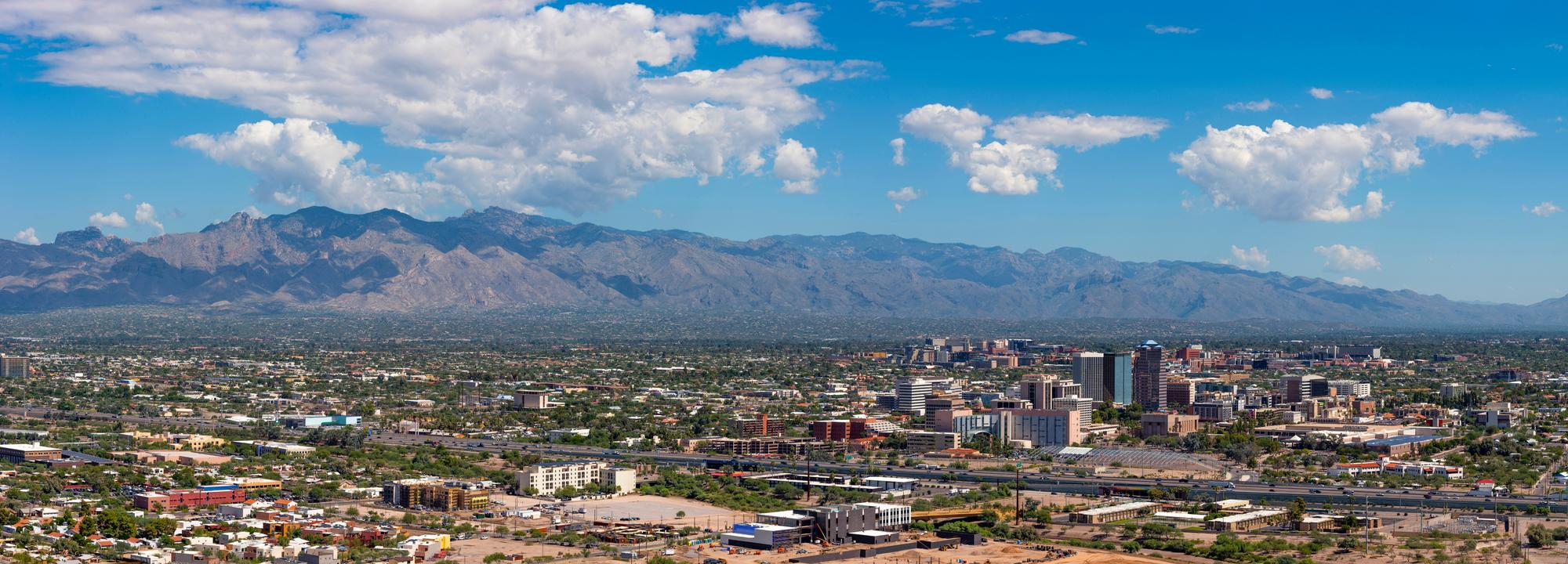 Panoramic aerial view of a Valley city with mountain ranges on the horizon