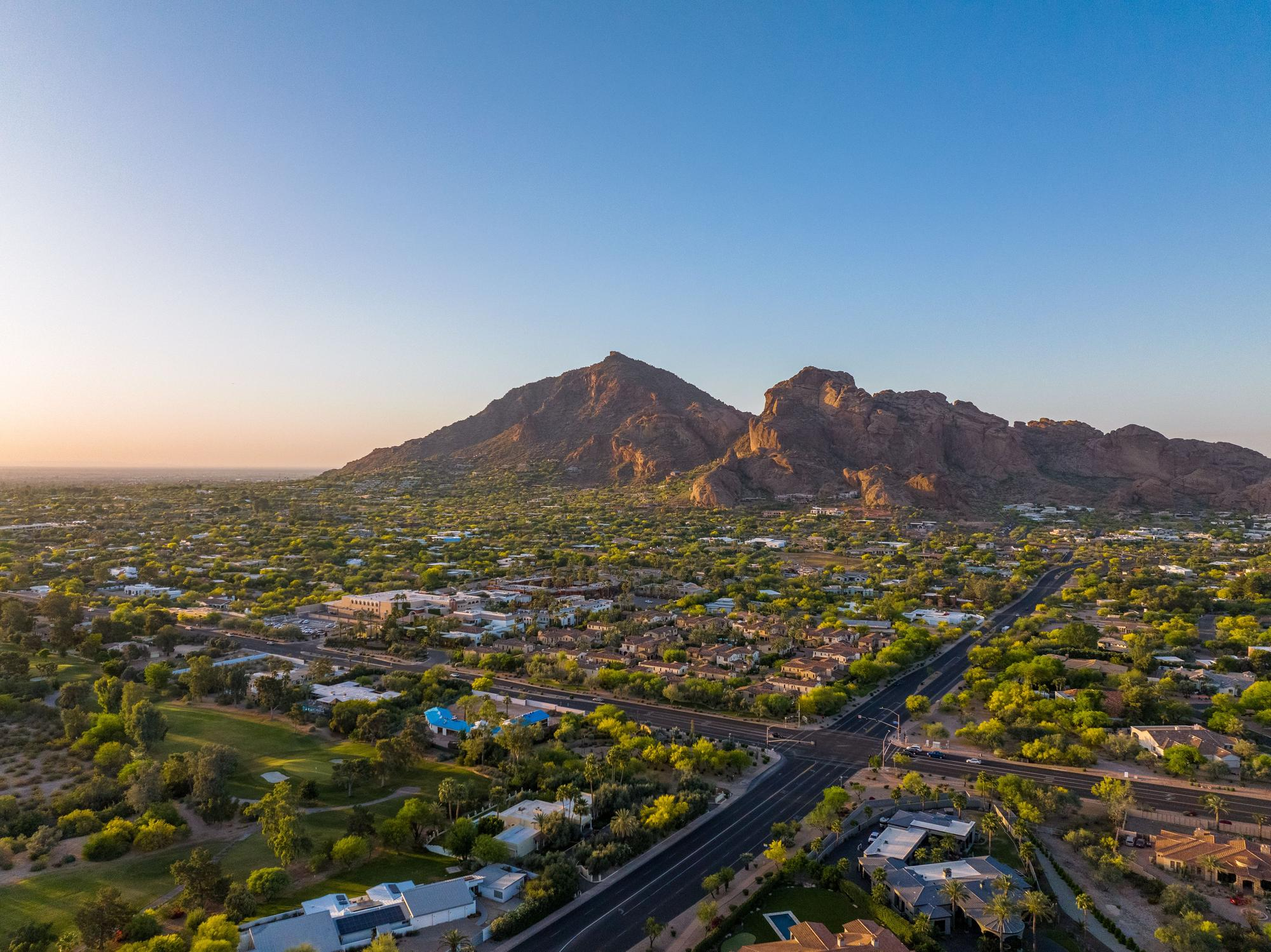 Camelback Mountain rising above green residential neighborhoods
