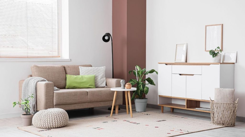 Neutral staged living room with a beige sofa and simple decor