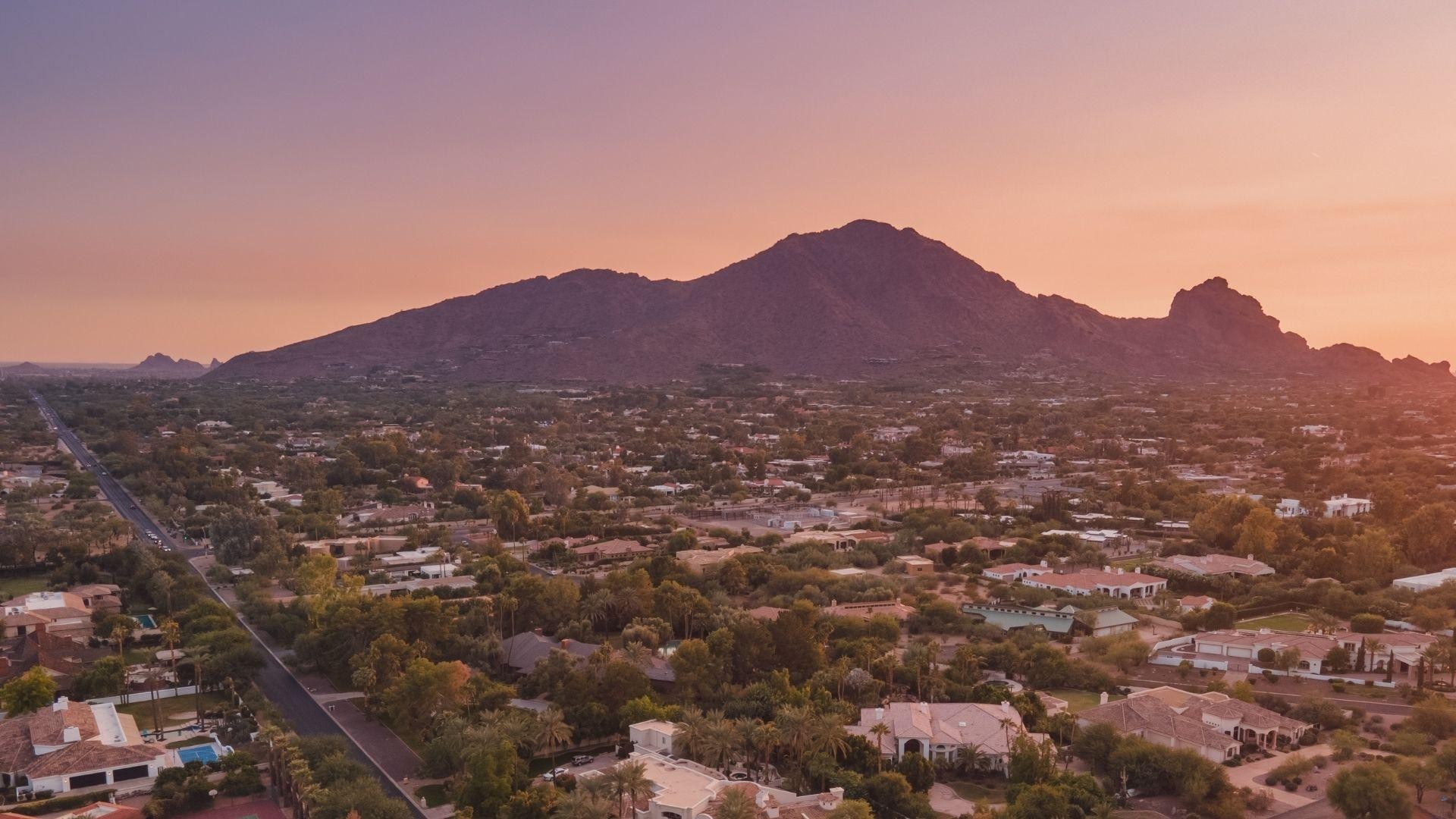 Camelback Mountain at dusk above Phoenix-area rooftops